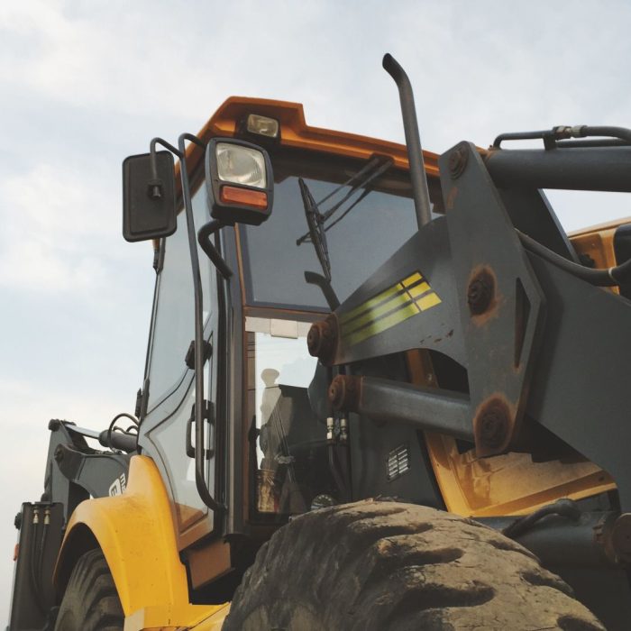 Motor grader on a road site