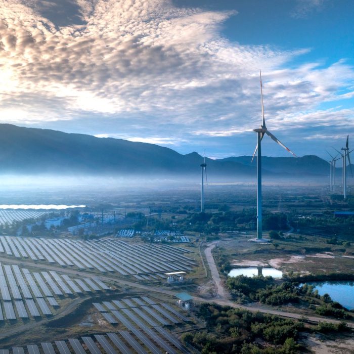 Aerial view of wind turbines and solar panels