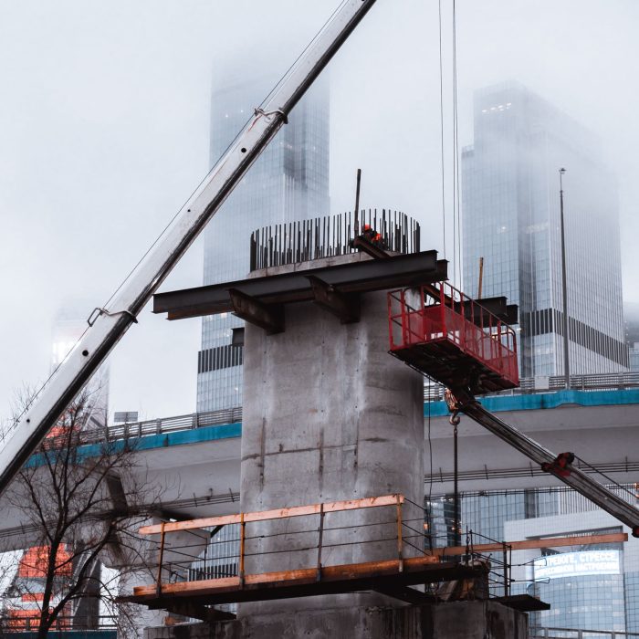 Crane assembling a concrete bridge structure