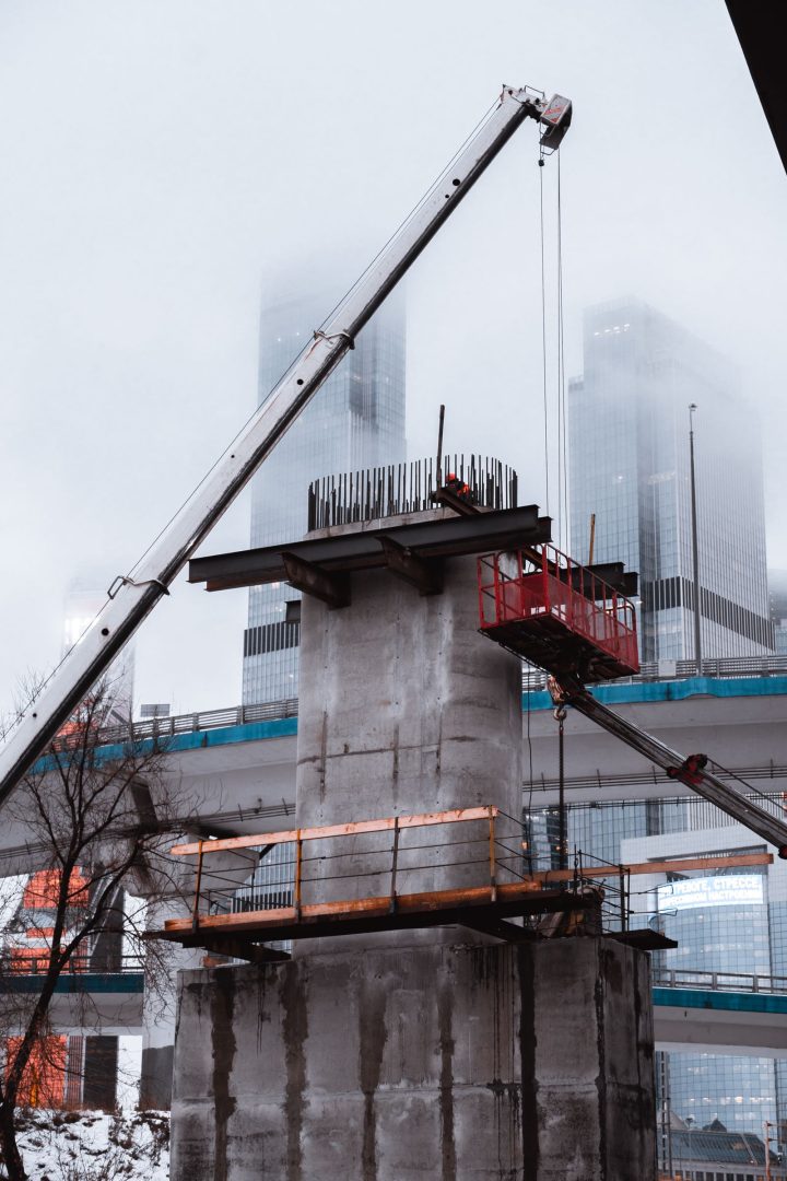 Crane assembling a concrete bridge structure